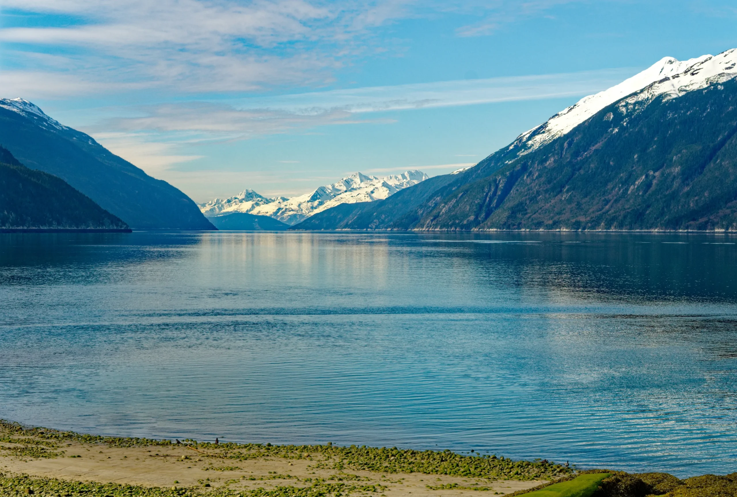 a lake with mountains in the background