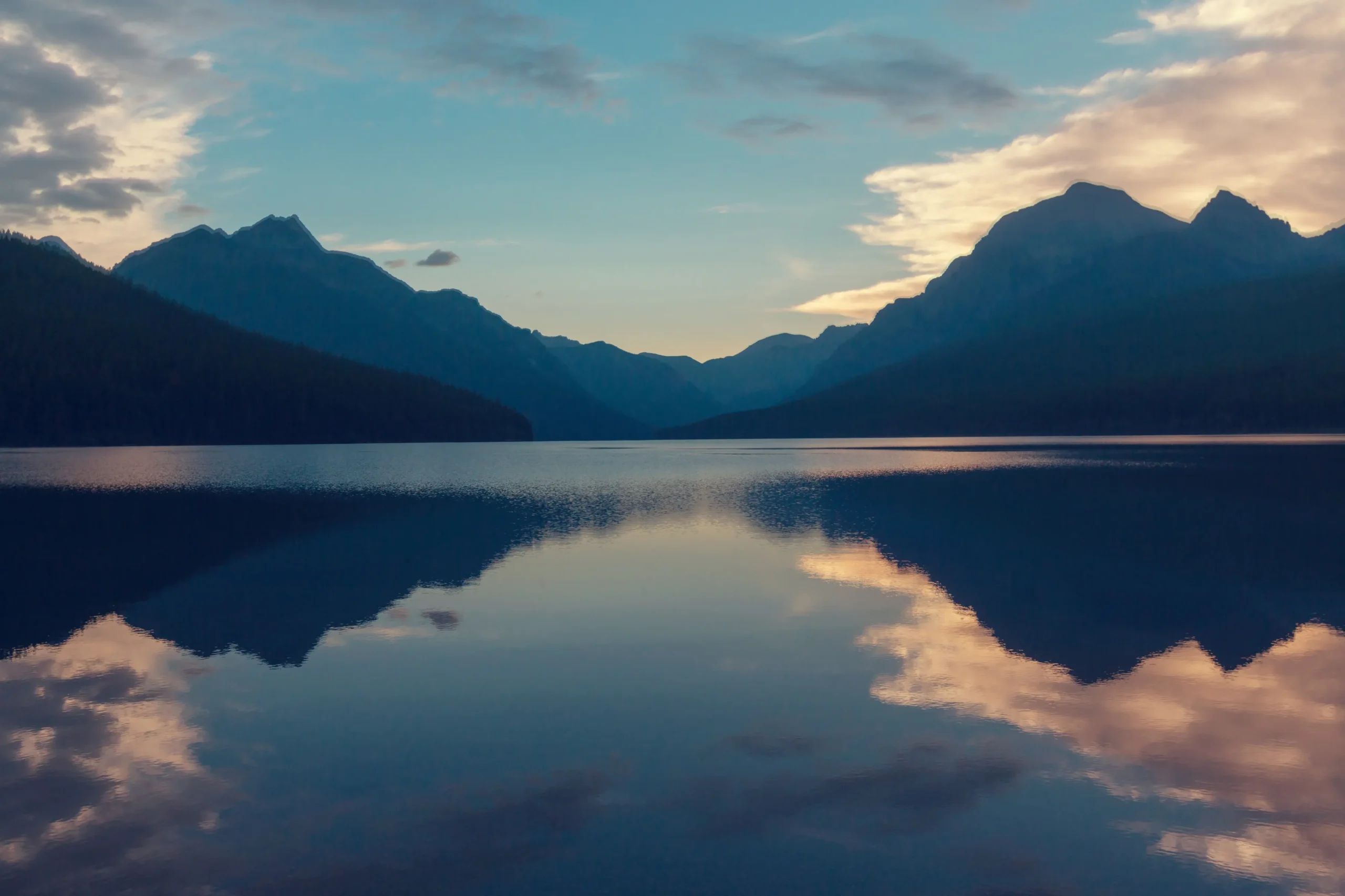 a lake with mountains in the background